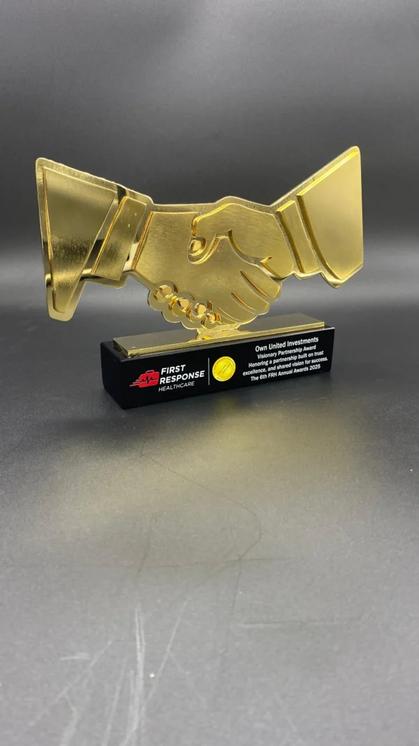 Hand shake metal and crystal trophy symbolizing partnership